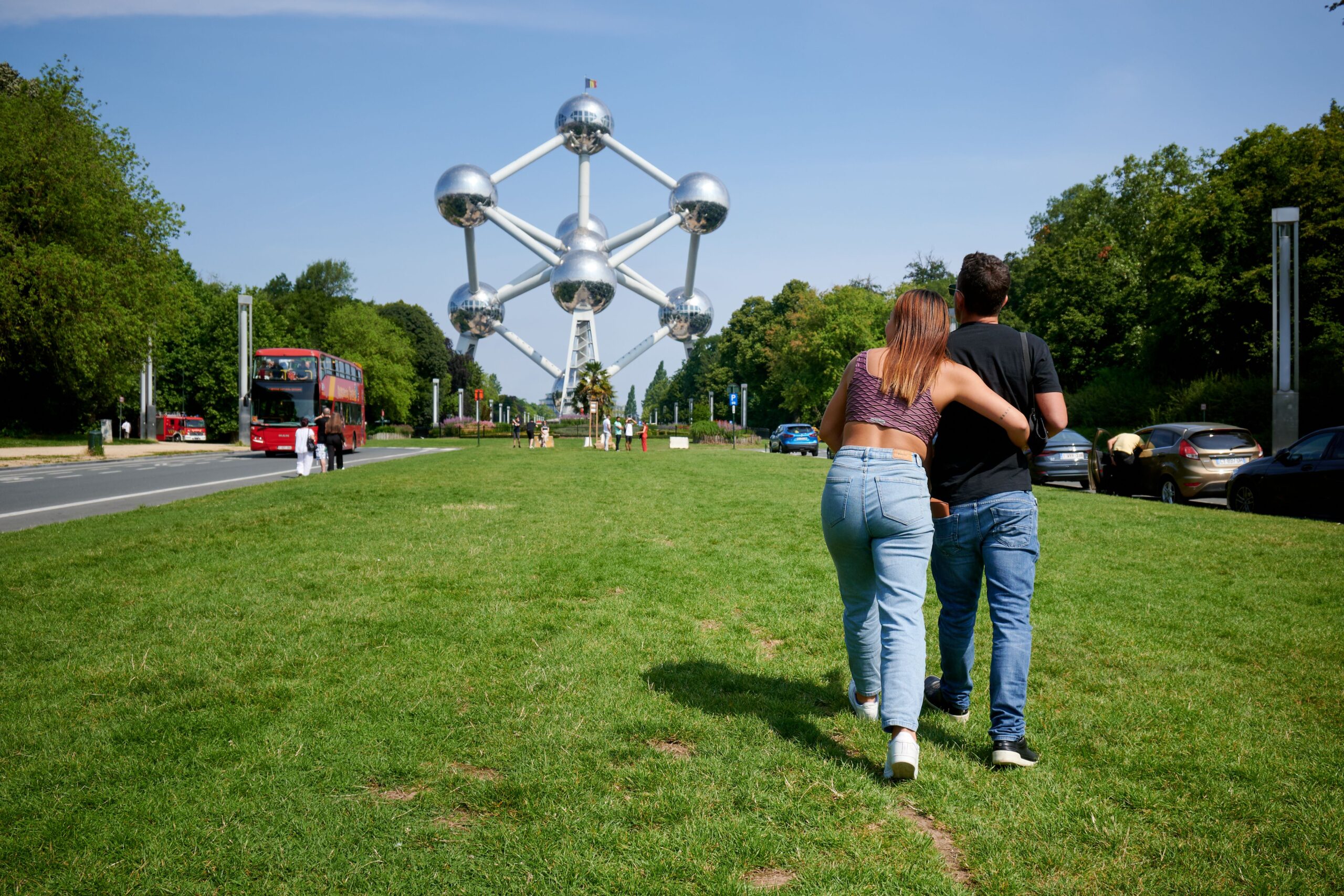 Back view of Hispanic couple walking towards the Atomium in Brussels