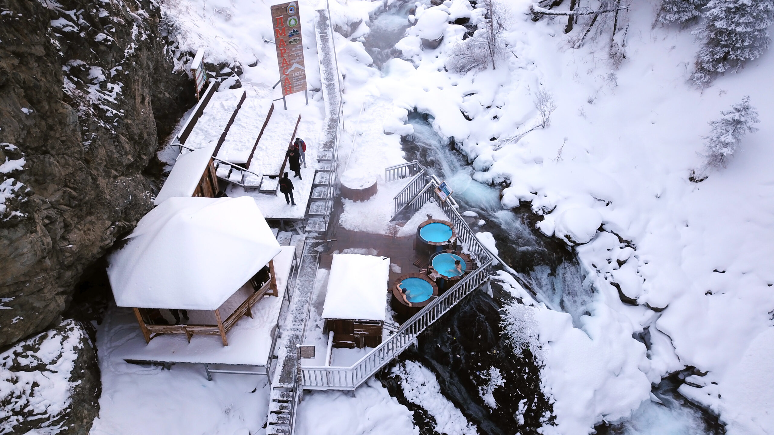 Hot springs in the snowy forest and mountains